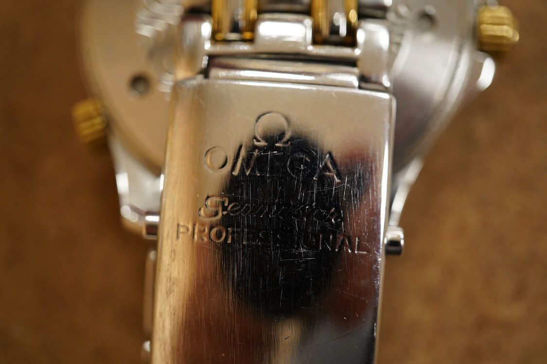 A gentleman's mid 1980's stainless steel and gold plated Omega Seamaster Professional Chronometer automatic wrist watch, with blue dial, dot numerals and date aperture, movement c.1109, case diameter 40mm, on an Omega st